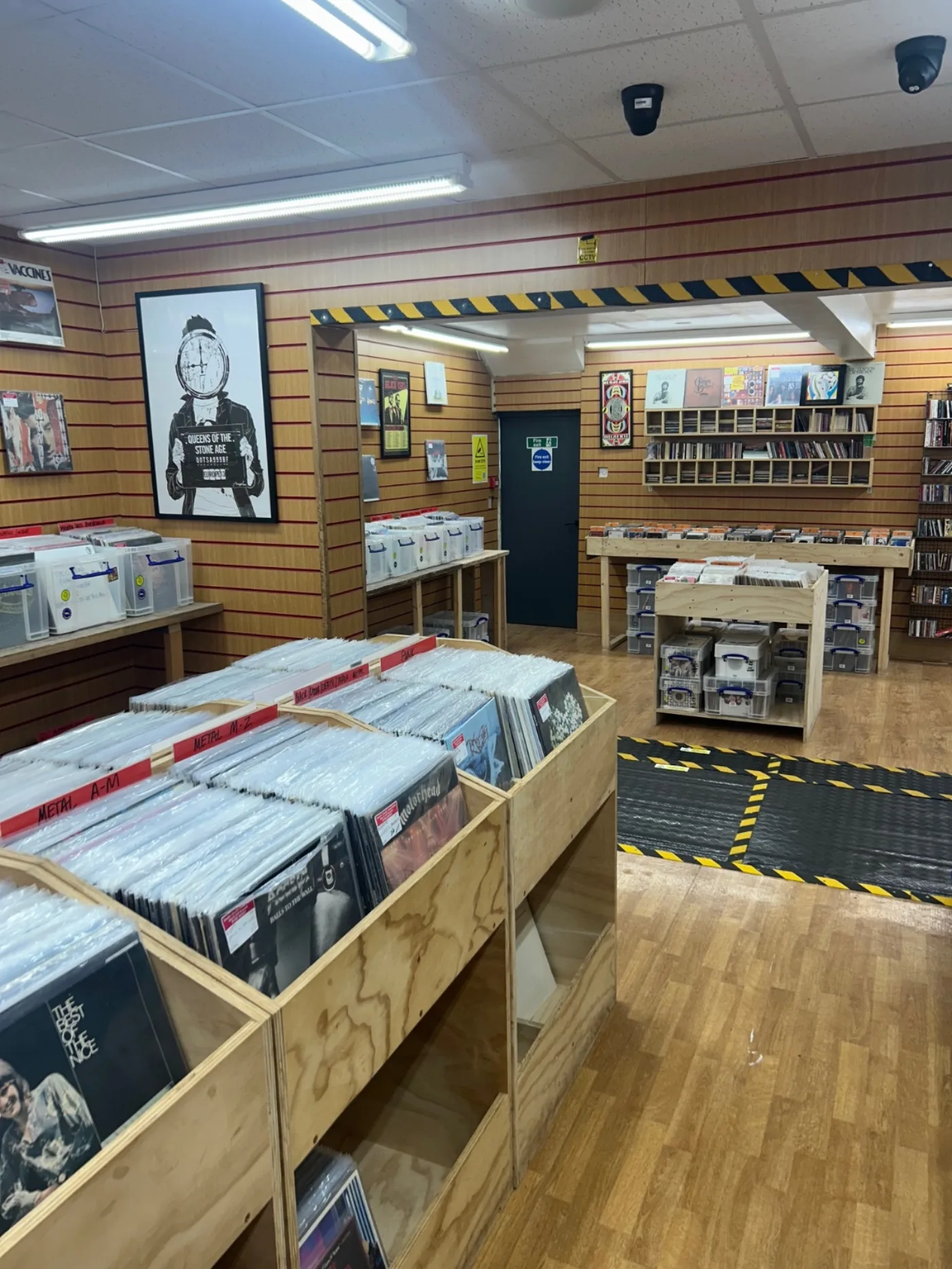 Wooden record bins arranged through the upper shop floor