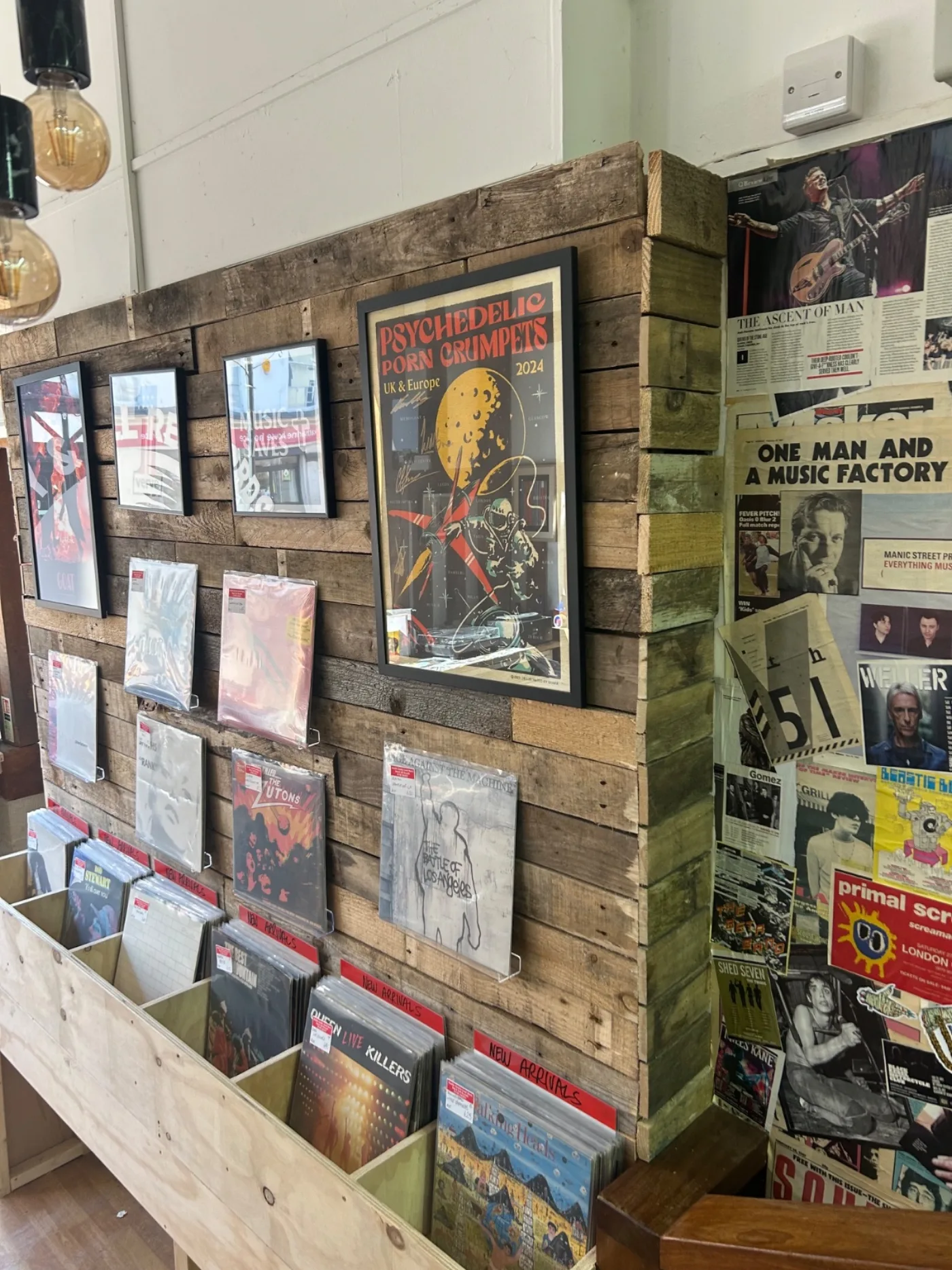 Feature display wall with framed posters and new arrivals