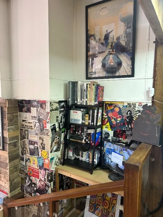 Music display corner with records, films, and framed artwork