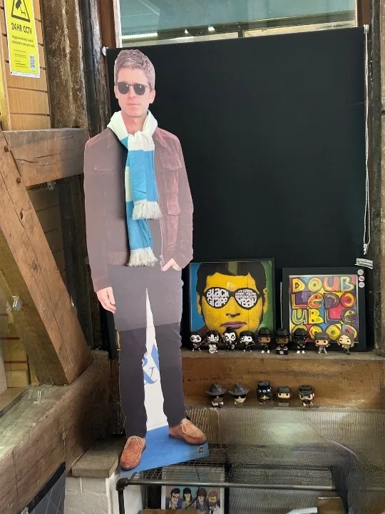 Display figure and collectibles beside Double Double Good artwork