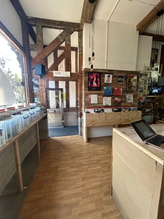 Front shop area with counter, record bins, and timber beams
