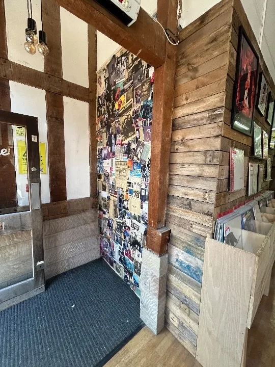 Entrance area with music collage wall and record bins