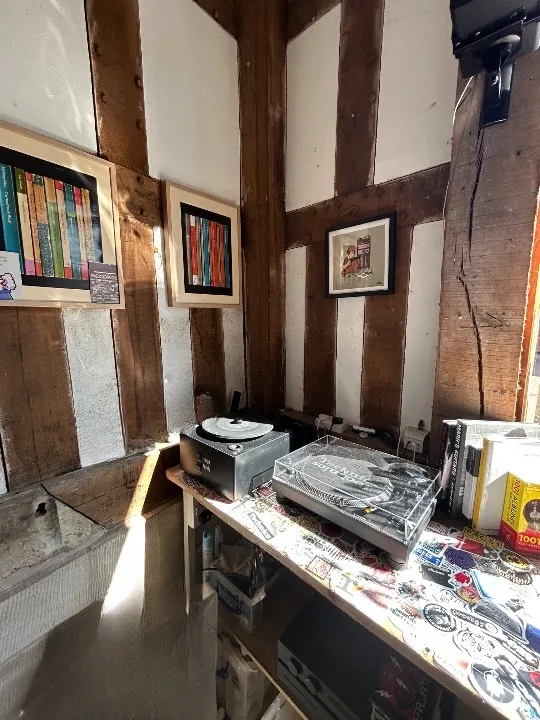 Turntables and framed artwork in the listening corner